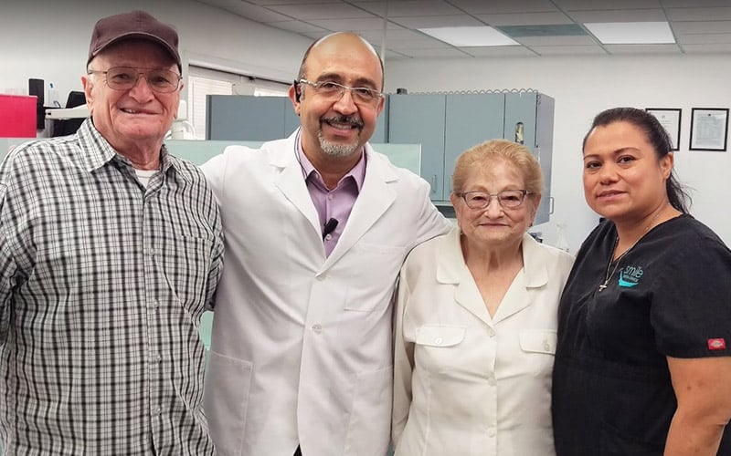 Dr. Harsini with patients and team member posing for photo