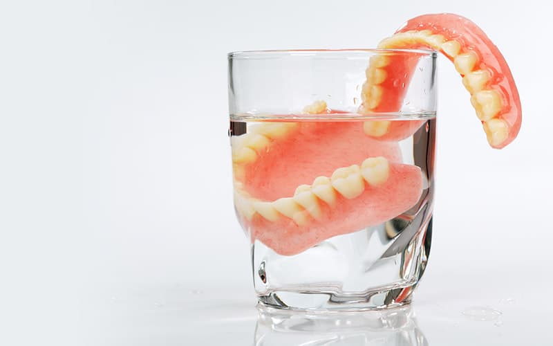 dentures in glass of water