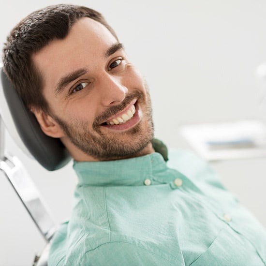 smiling man in dental chair